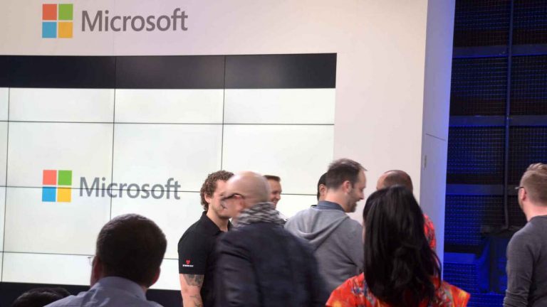 People standing in front of a Microsoft sign