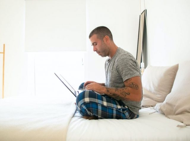 man seated on laptop using laptop
